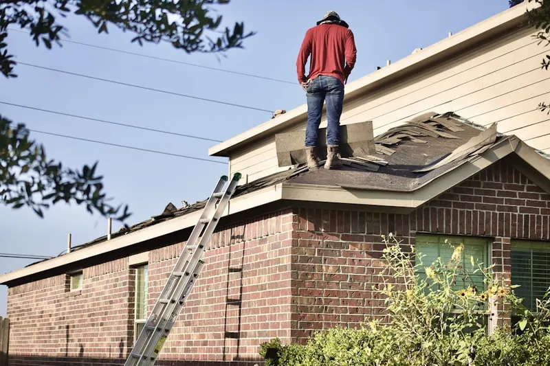 Professional roofer working on a residential roof in Cross Creek Estates